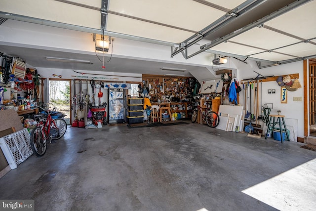 garage with a workshop area and a garage door opener