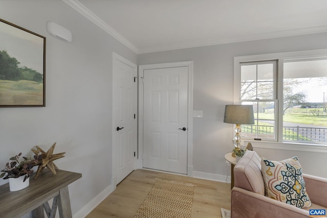 foyer entrance featuring ornamental molding and light hardwood / wood-style floors