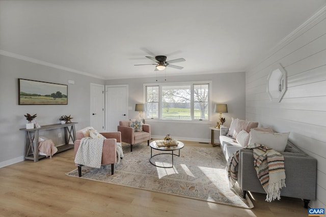 living room featuring ornamental molding, ceiling fan, and light hardwood / wood-style flooring