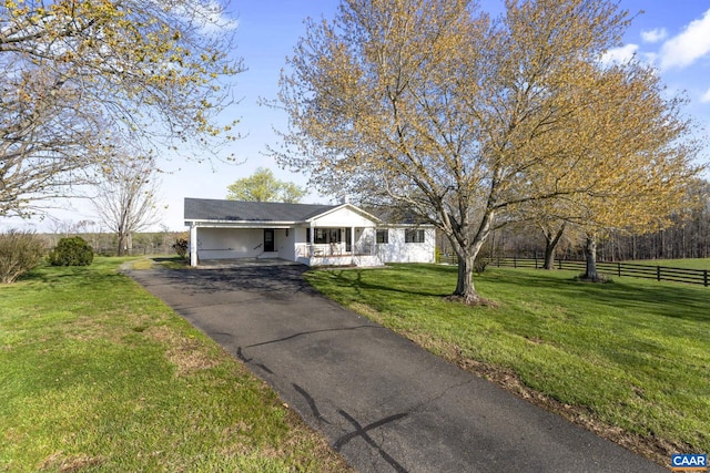 ranch-style house featuring a front lawn and a carport