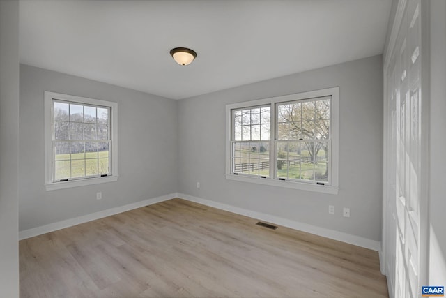 unfurnished room featuring light wood-type flooring