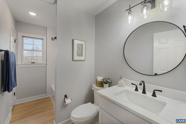 full bathroom with toilet, shower / washtub combination, wood-type flooring, and vanity