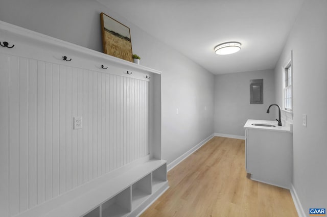 mudroom featuring sink and light hardwood / wood-style flooring