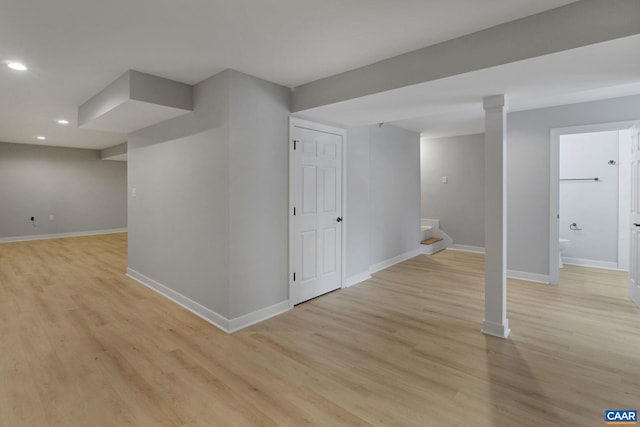 basement with light hardwood / wood-style floors