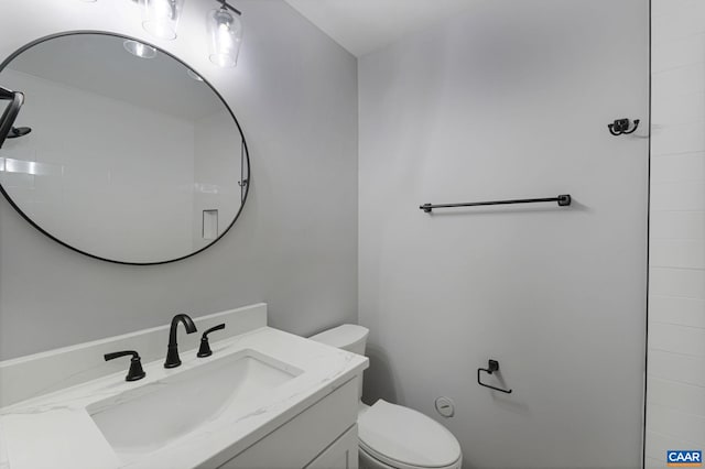 bathroom with toilet and vanity