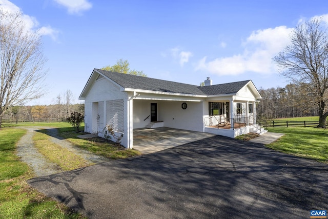 view of front of home with a front yard and covered porch