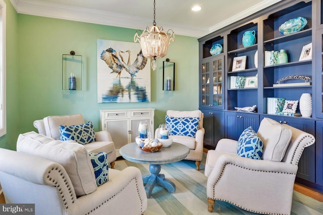 living area featuring a chandelier, crown molding, and hardwood / wood-style flooring