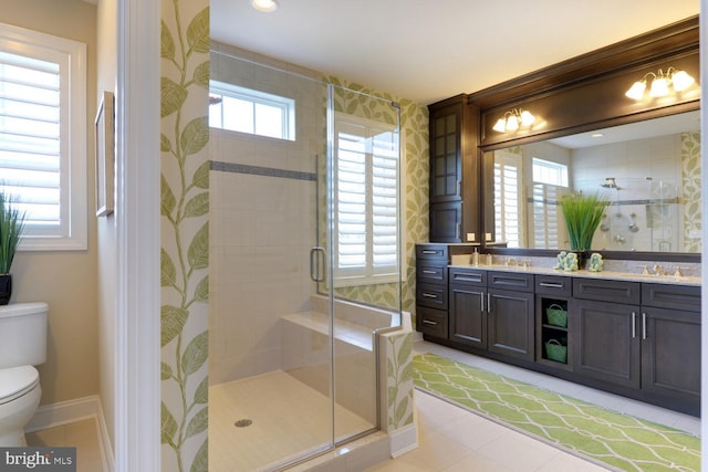 bathroom featuring dual vanity, tile flooring, toilet, and walk in shower