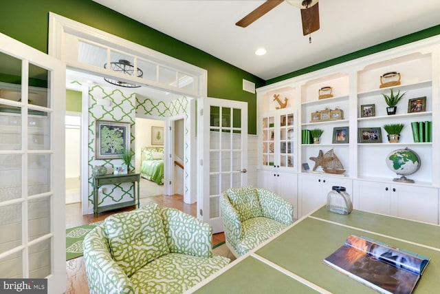 rec room featuring light hardwood / wood-style floors and ceiling fan