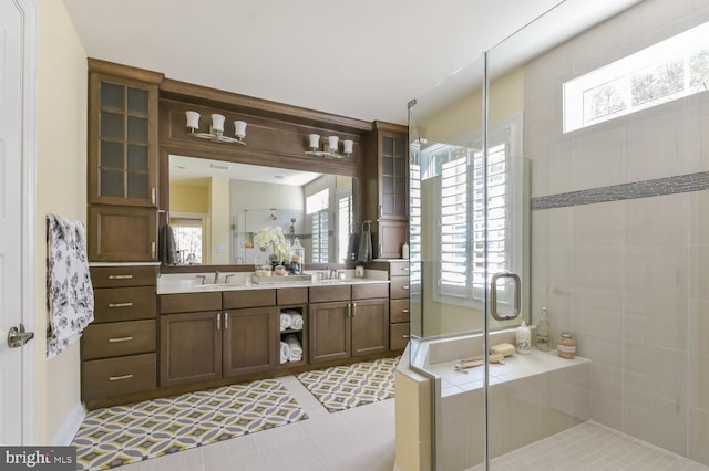 bathroom featuring plenty of natural light, shower with separate bathtub, tile flooring, and oversized vanity