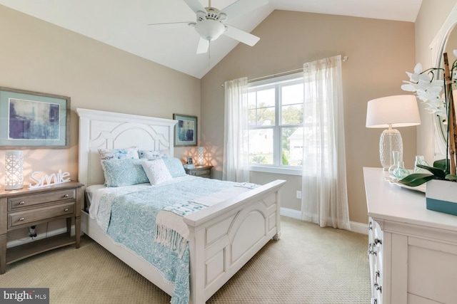 bedroom with lofted ceiling, ceiling fan, and light carpet