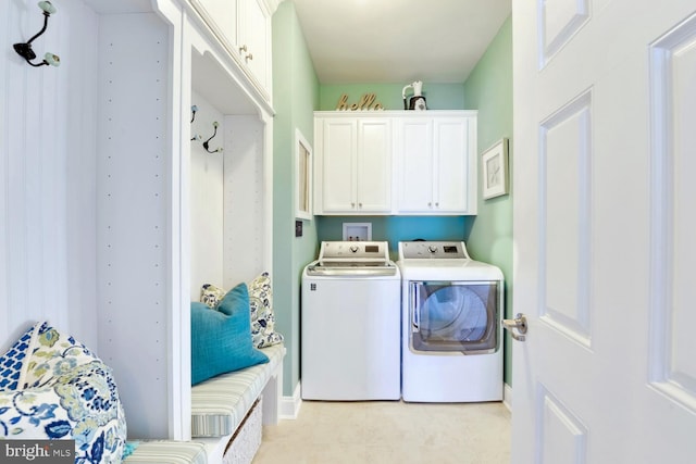 washroom featuring light tile flooring, washing machine and dryer, cabinets, and hookup for a washing machine