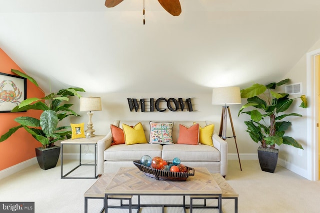 carpeted living room with ceiling fan