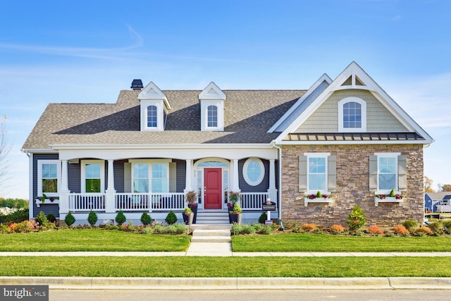 view of front of home with a porch and a front yard