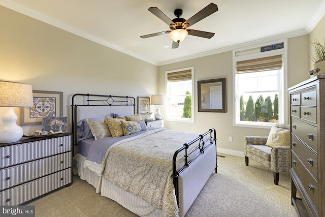 carpeted bedroom featuring ceiling fan and crown molding