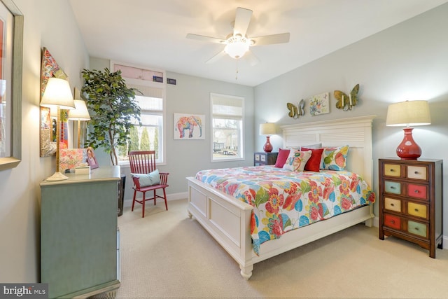 bedroom with light colored carpet and ceiling fan