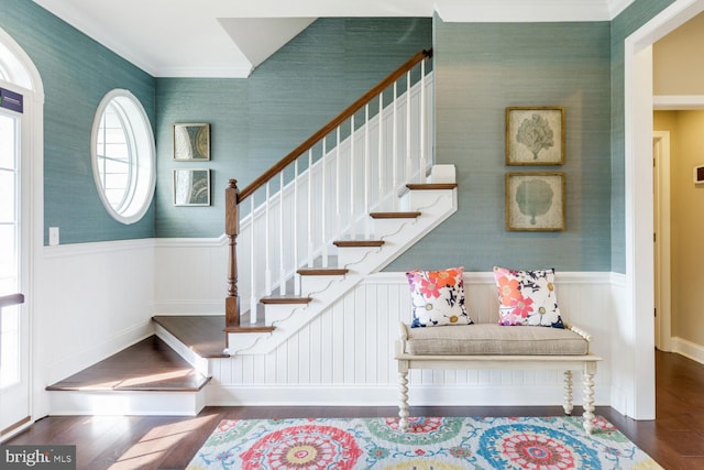 staircase with crown molding and dark hardwood / wood-style floors