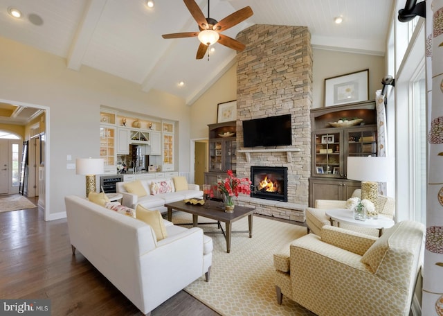 living room featuring high vaulted ceiling, a fireplace, ceiling fan, wine cooler, and dark wood-type flooring