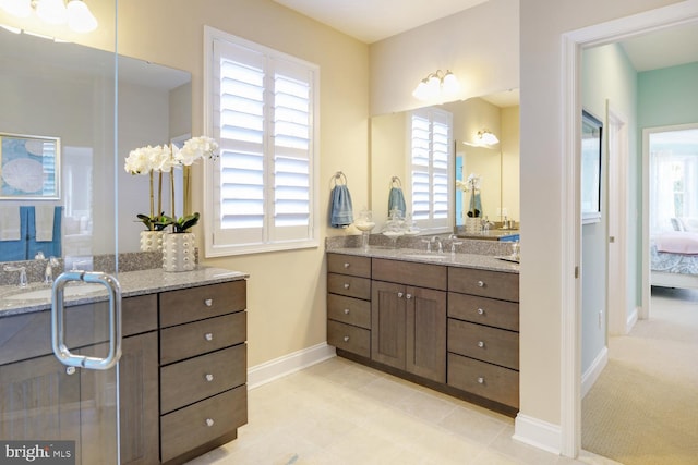 bathroom featuring vanity, a wealth of natural light, and tile flooring