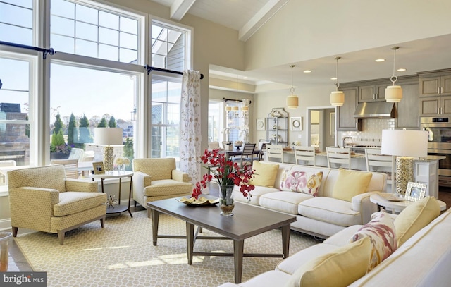 living room with high vaulted ceiling and beamed ceiling