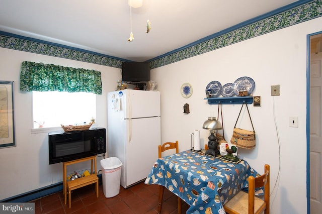 bedroom featuring white refrigerator and dark tile floors