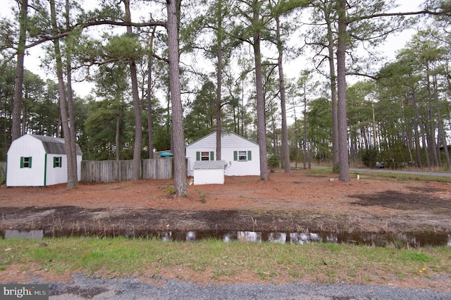 view of front facade with an outdoor structure and a water view