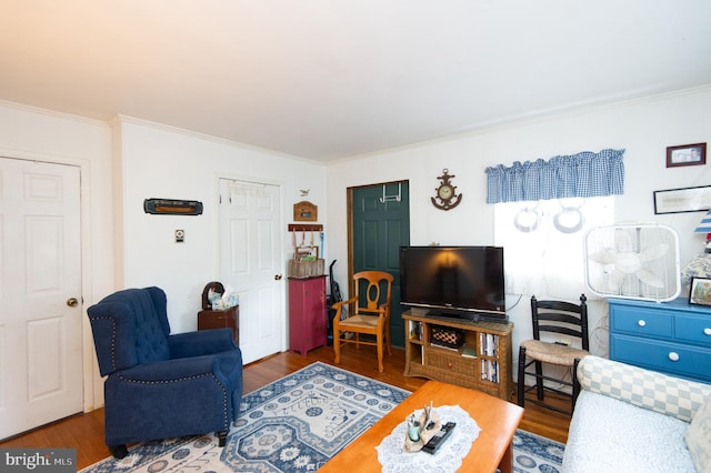 living room featuring ornamental molding and dark hardwood / wood-style floors