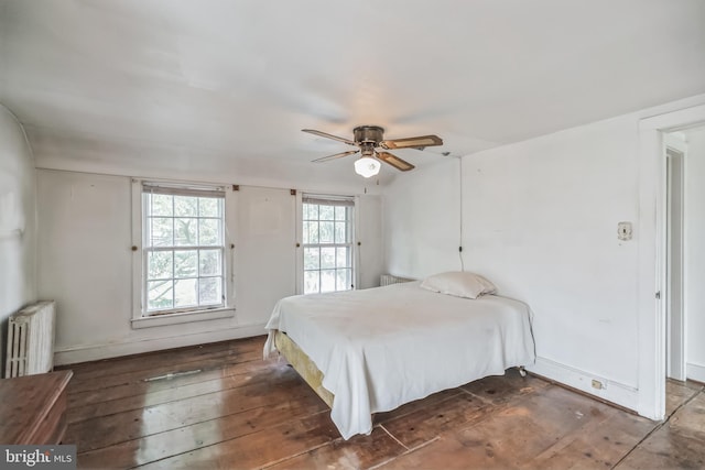 bedroom featuring ceiling fan, dark wood-type flooring, and radiator