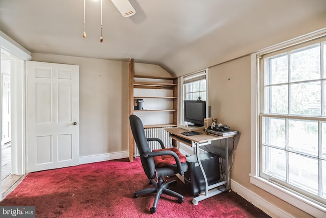 carpeted office with ceiling fan, a wealth of natural light, and vaulted ceiling