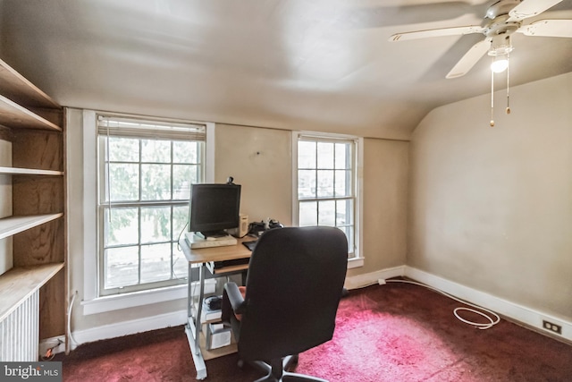 carpeted office space featuring vaulted ceiling and ceiling fan