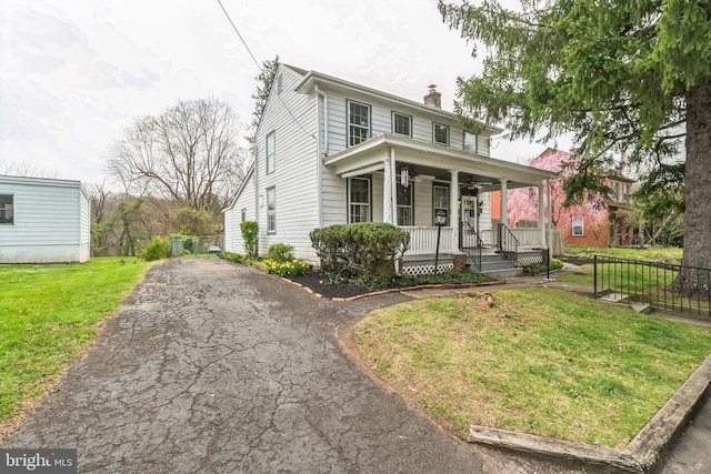 view of front of home with a porch and a front yard