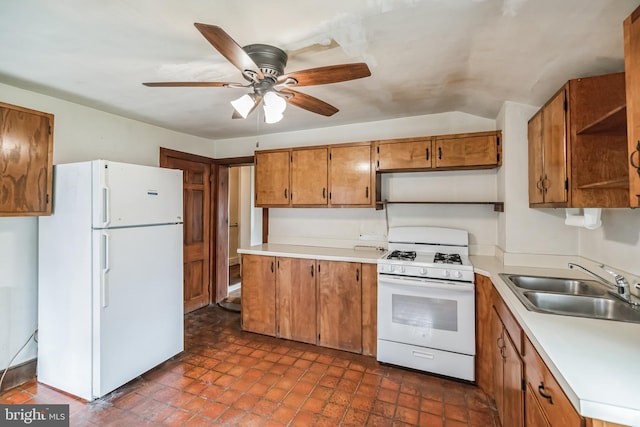 kitchen featuring vaulted ceiling, ceiling fan, sink, and white appliances