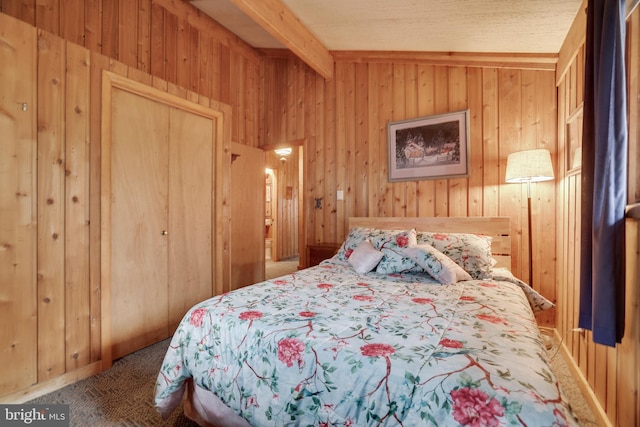 carpeted bedroom with a closet, vaulted ceiling with beams, and wooden walls