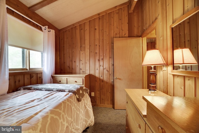 bedroom with vaulted ceiling with beams, light colored carpet, and wooden walls