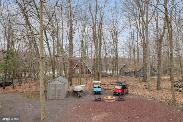 exterior space featuring a fire pit and a shed