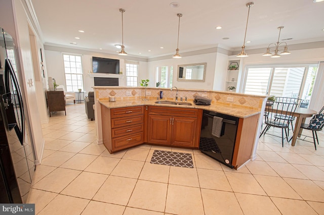 kitchen with black dishwasher, plenty of natural light, hanging light fixtures, and sink