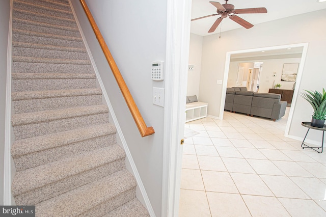 stairway with tile patterned floors and ceiling fan