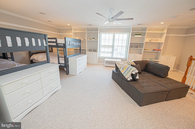 carpeted bedroom with ceiling fan and ornamental molding