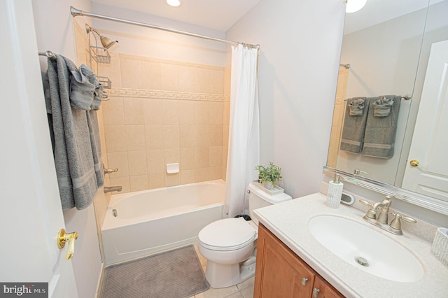 full bathroom featuring tile patterned floors, shower / bath combo with shower curtain, vanity, and toilet