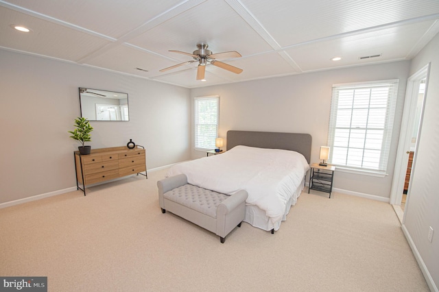 carpeted bedroom featuring multiple windows and ceiling fan