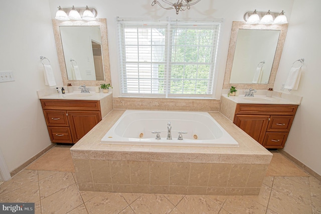 bathroom featuring vanity, a relaxing tiled tub, and a wealth of natural light