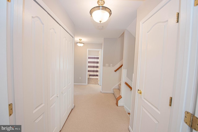 hallway with light colored carpet