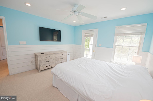 carpeted bedroom featuring access to exterior and ceiling fan