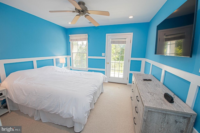 bedroom with light carpet, access to outside, and ceiling fan