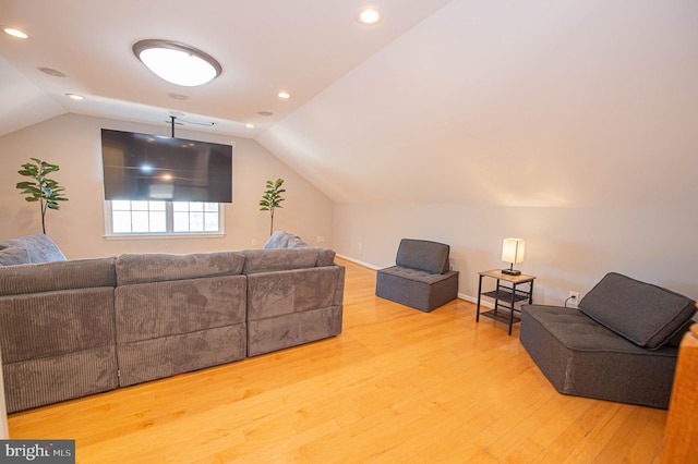 living room with wood-type flooring and vaulted ceiling