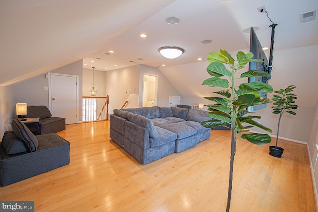 living room with vaulted ceiling and light hardwood / wood-style flooring