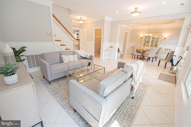 living room with crown molding, light tile patterned floors, and an inviting chandelier