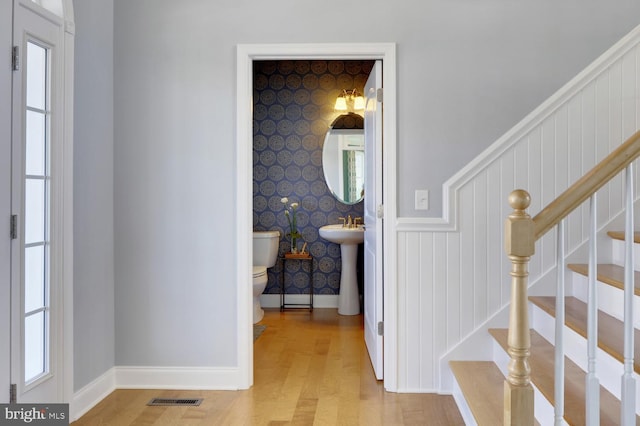 hallway with sink and light wood-type flooring