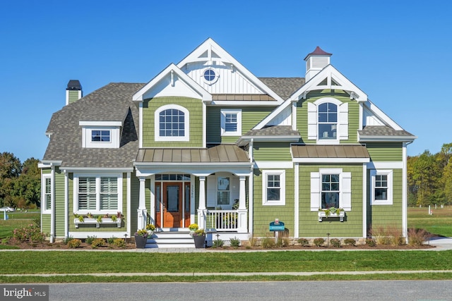 view of front of property with a porch and a front lawn