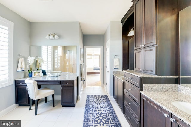 bathroom featuring plenty of natural light, tile floors, and double vanity